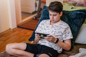 Lazy Teenager watching Video game, Indoors